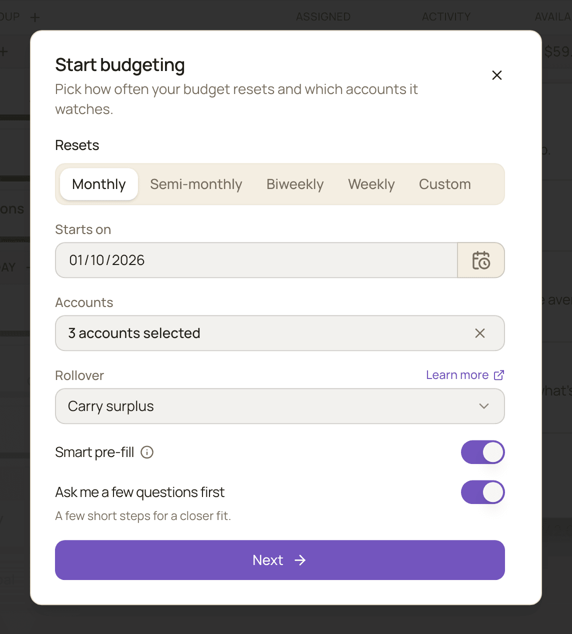 The Start budgeting window with Monthly selected under Resets, the Starts on date, three accounts selected, Carry surplus as the Rollover rule, the Smart pre-fill and Ask me a few questions first switches turned on, and the Next button.